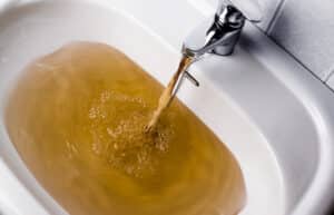 Dirty brown water running into a sink, Water Line Repairs.