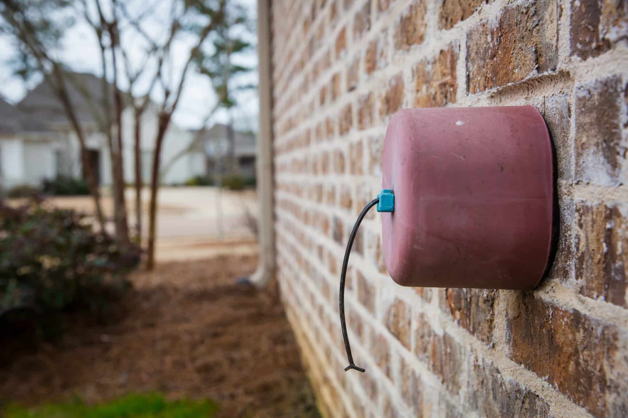 Faucet cover on exterior brick wall, Plumbing.