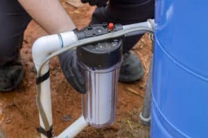 Maintenance worker replaces a filter at a domestic water treatment facility, Water Purity.